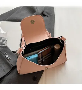 Interior view showing large capacity and zipper pocket of pink leather crossbody bag