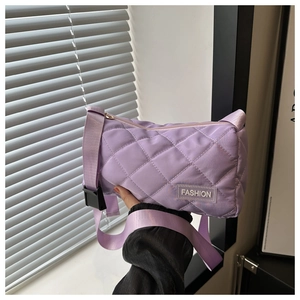 Detailed shot of purple quilted tote bag with diamond stitching and Fashion label