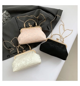Detailed view of vintage jacquard fabric bags with floral texture and metal ring handles