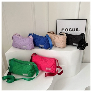 Quilted nylon tote bags shown in six colors on geometric stands with adjustable straps