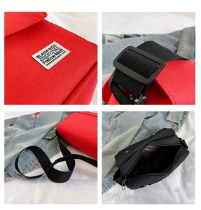 Detail of canvas messenger bag featuring a Black Rice label and adjustable nylon strap