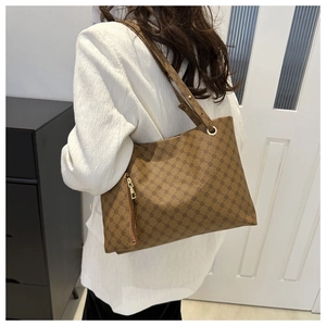 Detail of dark brown tote bag with geometric pattern and detachable mini zip pouch