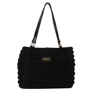Minimalist black bubble textured tote bag with FASHION label and thin shoulder straps