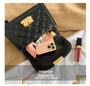 Detail view showing internal capacity of black quilted crossbody bag with golden hardware