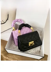 Detail of quilted mini crossbody bags with gold push-lock and ruched handles in gift box