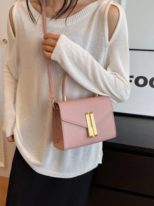 Pink textured leather satchel with golden buckle, crossbody strap, and top handle