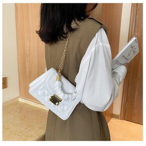 White quilted crossbody bag with gold chain strap and unique ruched cloud top handle
