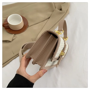 Detailed view of the double-compartment interior and gold magnetic clasp on the plaid bag