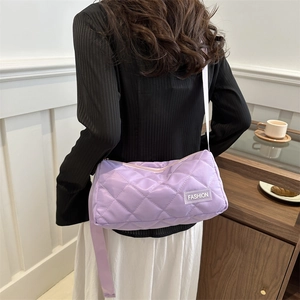 Light purple quilted cylinder tote bag with FASHION label and adjustable strap