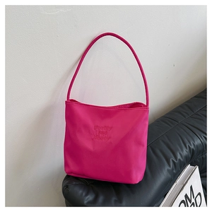 Detail van roze draagtas met pretty and libety borduursel op nylon materiaal