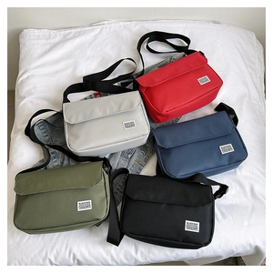 Detailed top view of five durable canvas crossbody bags in assorted vintage colors