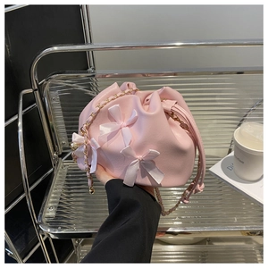 Vue détaillée du sac seau à cordon rose élégant avec des nœuds en ruban décoratifs