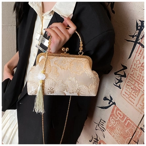 Detail of Chinese style silk handbag with gold floral embroidery and decorative tassel
