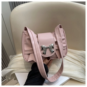 Close-up of pink pleated shoulder bag with a silver metallic bow decoration