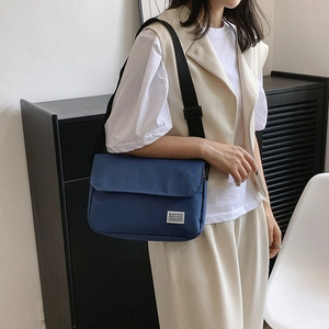 Dark blue canvas messenger bag with adjustable strap and flap closure for casual style