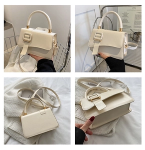 Detailed view of cream white PU leather handbag featuring a large buckle and gold hardware