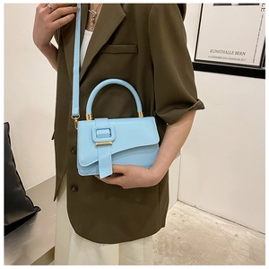 Close-up of light blue PU leather handbag featuring an irregular flap and square buckle
