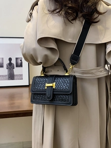 Fashionable black woven texture crossbody bag with adjustable wide strap and gold buckle