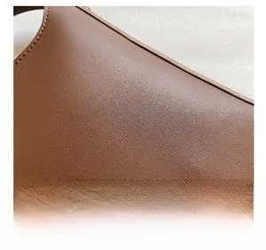 Close-up of brown litchi pattern leather texture with detailed soft grain finish