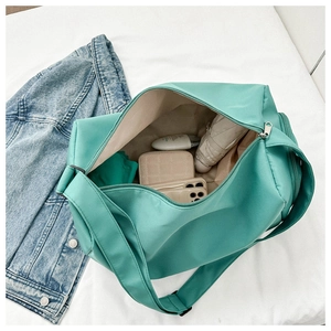 Interior view of mint green oxford travel bag showing umbrella and wallet storage space