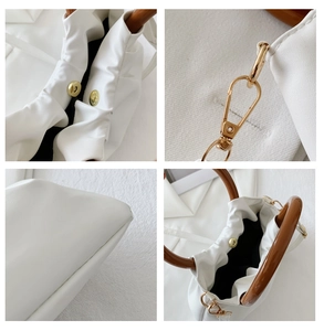 Close-up of white ruched bag details with wooden handle and gold magnetic hardware