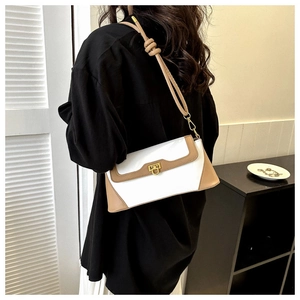 Detail of vintage bicolor baguette bag with white leather, khaki trim and gold lock