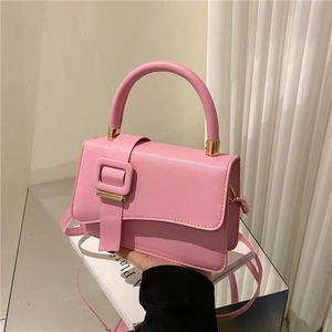 Pink minimalist single shoulder bag with top handle and decorative gold buckle