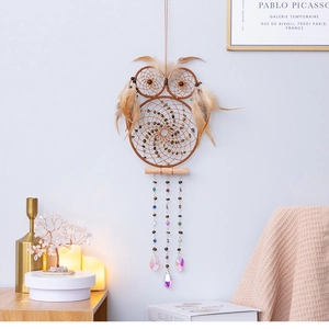 Detail of owl dream catcher featuring crystal prisms, feathers and beaded tassels