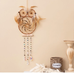 Detail of owl dream catcher featuring brown feathers and hanging crystal prism pendants