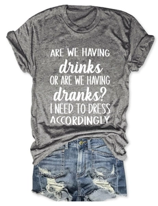 Flat lay of grey short sleeve T-shirt with white text and vintage denim shorts
