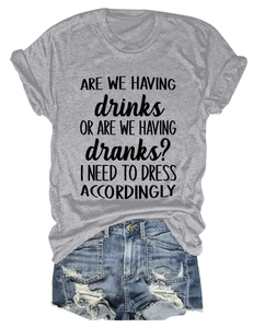 Detail of grey crewneck t-shirt with text paired with distressed denim shorts