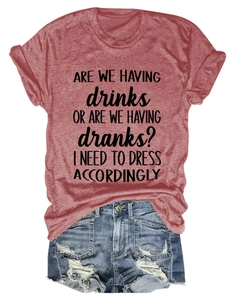 Detail of red crew neck t-shirt with slogan paired with frayed denim shorts set