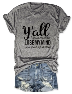 Flat lay of a grey heather crew neck t-shirt with text and ripped denim shorts