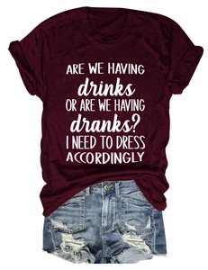 Flat lay of wine red slogan T-shirt paired with distressed denim shorts for summer