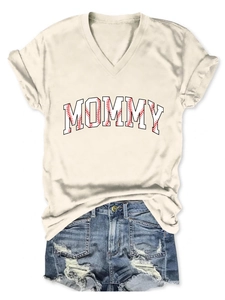 Close-up of beige V-neck t-shirt with MOMMY baseball print and rolled sleeve details