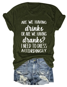Flat lay of green t-shirt with funny drinks slogan and ripped blue denim shorts set