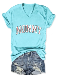 Flat lay of mommy printed v-neck t-shirt and distressed denim shorts summer outfit