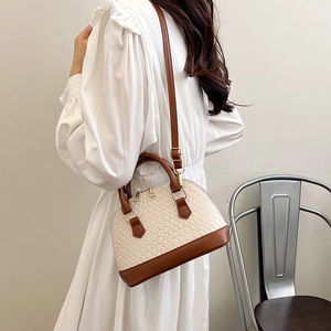 Sac bandoulière en maille crème avec finitions en cuir marron et détails dorés