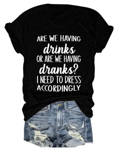 Detail of white slogan print on black cotton t-shirt with denim shorts accessory