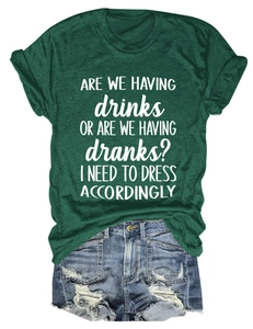 Flat lay of green cotton T-shirt with white slogan and distressed denim shorts set