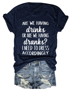 Flat lay of navy crew neck tee with white slogan print and ripped denim shorts