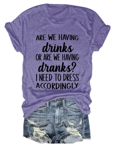Flat lay of purple cotton T-shirt with humorous slogan and ripped denim shorts