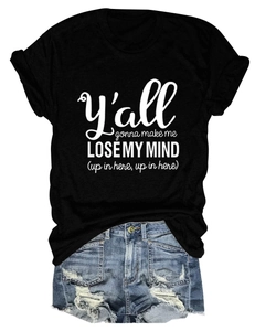 Flat lay of black cotton t-shirt with artistic slogan and distressed denim shorts set