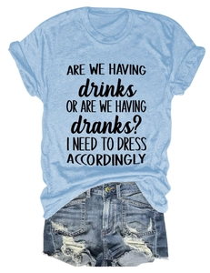 Flat lay of light blue crew neck t-shirt with text and distressed denim shorts ensemble