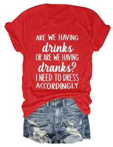 Flat lay of a red cotton crewneck t-shirt paired with distressed denim fringe shorts