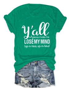 Detail of green cotton t-shirt with white letter print and ripped denim shorts