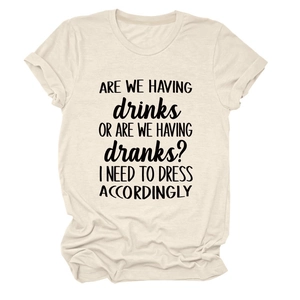 Detail of cream crewneck tee with humorous 'ARE WE HAVING drinks' slogan and cotton texture