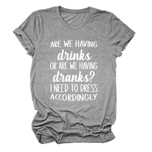 Flat lay of gray cotton T-shirt with rolled sleeves and white quote print text