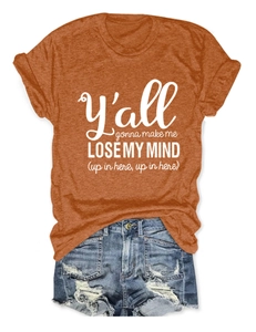 Flat lay of an orange crew neck cotton t-shirt with text and ripped denim shorts
