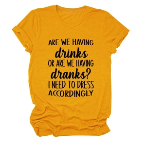 Detail of yellow cotton T-shirt featuring black 'ARE WE HAVING DRINKS' slogan print
